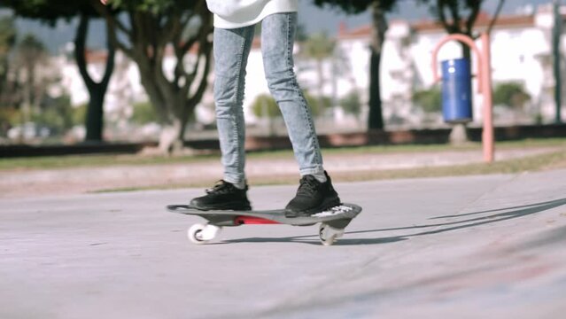 Legs on waveboard close up, Girl riding on casterboard with two wheels, modern street skate sports of teenagers, ripstick for balance ride.