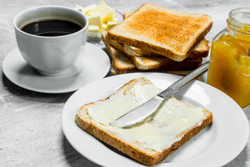 Toasted bread with butter and hot coffee.