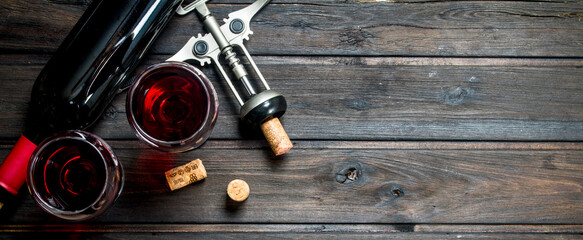 Wine background. Red wine with corkscrew.