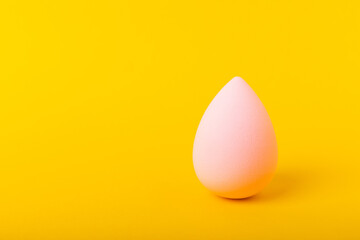 Beauty blender on yellow background.Bright sponges for make-up cosmetics. Makeup products. Beauty concept. Place for text. Space for copy. Flat lay