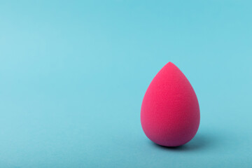 Beauty blender on blue background.Bright sponges for make-up cosmetics. Makeup products. Beauty concept. Place for text. Space for copy. Flat lay