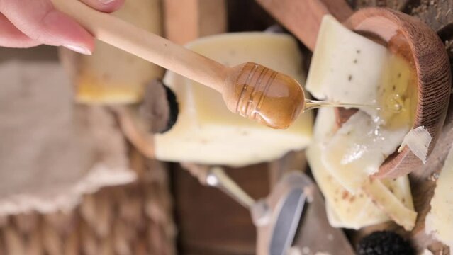 Pecorino cheese with truffle, traditional Italian sheep's milk cheese with truffle. A typical product of the dairy regions of Tuscany and Sardinia. Honey and cheese. High quality HD video. Vertical