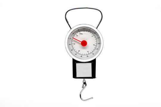 Hand held weight scale with hook for weighing travel suitcases on a plain white background. Copy space.