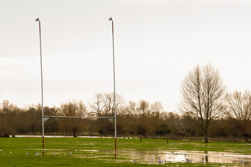 Flooded sports pitch after heavy rain the field is waterlogged