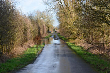 Fototapeta premium A view on a flooded road in rural Oxfordshire in winter.. 