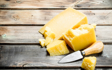 Parmesan cheese with knife.