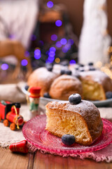 Christmas timChristmas time in Italian tradition. Biscuit holiday cake with berries on the table in Italian tradition. Biscuit birthday cake with berries on the table. 