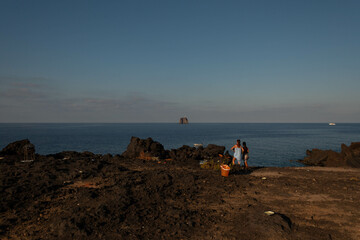 Strombolicchio Rock Formation at Sunset, Stromboli Island with Visitors