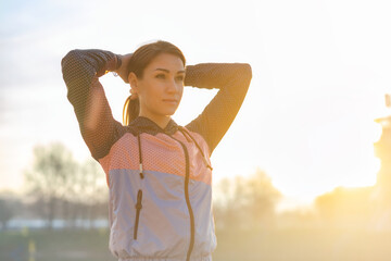 Portrait of athletic woman in a sportswear before evening run on city street. Healthy lifestyle concept