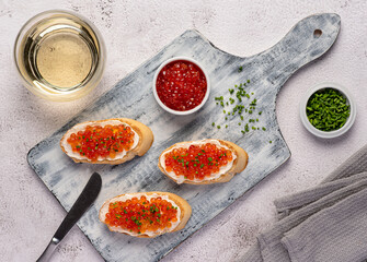 Food photography of sandwich with caviar, chive, white wine, starter, delicacy
