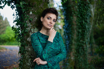 Naklejka premium very beautiful woman with fashion make-up in a long evening dress