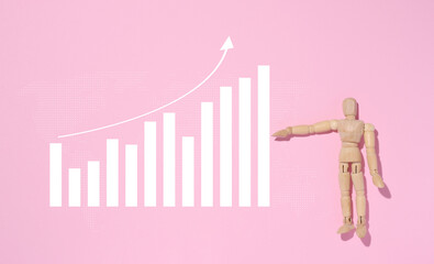 Wooden mannequin and graph with growing indicators, high income