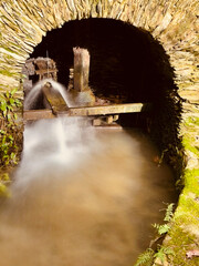 Old mill on the bank of the river Lourido in the park of the fountain of Stanislaus