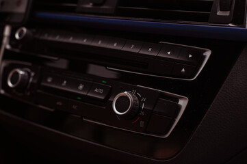 Radio tape recorder in the car. Black panel with buttons and music control. High quality photo