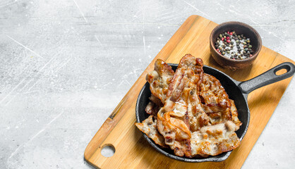 Fried bacon with spices.
