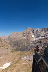 Young traveler taking photo with a phone over the mountain