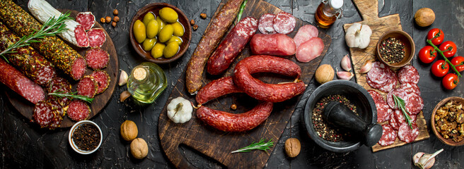 Variety of smoked salami with olives, herbs and spices. - 561652635