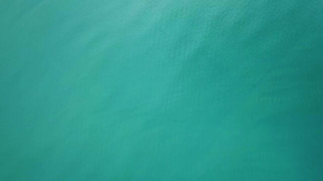 Flying over tropical turquoise sea water surface, top view 4k