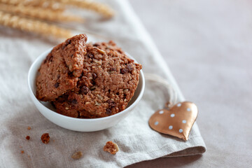 Homemade cookies with cereal and seeds, bowl on a table