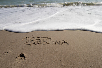 North Carolina written in the sand