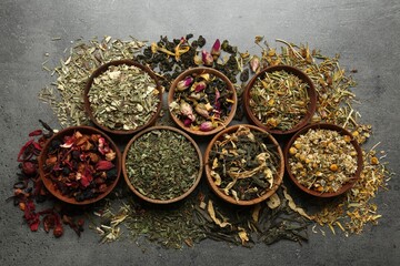 Flat lay composition with different dry teas on grey table
