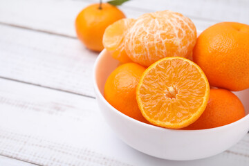 Fresh juicy tangerines on white wooden table, space for text