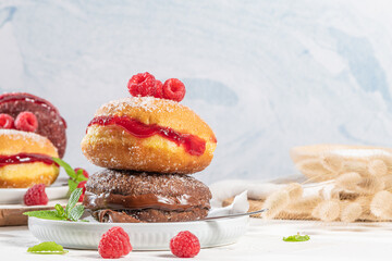 Bolas de Berlim, or Berlin Balls. Portuguese fried dough with sugar, Filled with chocolate or raspberry jam. Portuguese fried dough with sugar. Chocolate and  beetroot  berliner