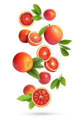 Red oranges with green leaves falling on white background