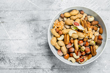 Different kinds of nuts in bowl .