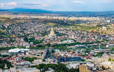 Aerial view of old town and modern architecture of Tbilisi, Georgia from Mtatsminda hill. Skyline and cityscape of Cathedral and popular tourist attractions in Tiflis