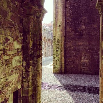 Looking through doorway to arches in the background, Boyle Abbey, Ireland.