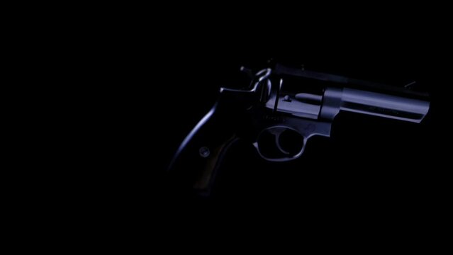 .357 HANDGUN SPINNING IN THE AIR DISINTEGRATES.  SHOT IN 4K, 10 BIT, 4:2:2, FULL FRAME, LOG.  NO PEOPLE.
