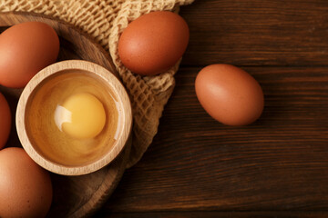Raw chicken eggs on wooden table, flat lay. Space for text