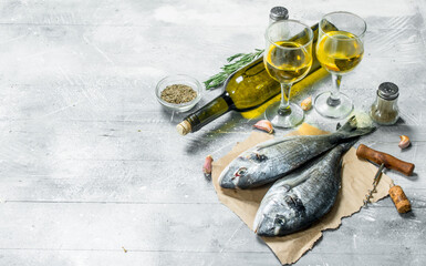 Raw sea fish dorado with white wine and spices.