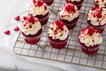 Red velvet cupcakes on a cooling rack