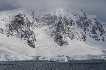 Great snowy Antarctic mountain above the sea