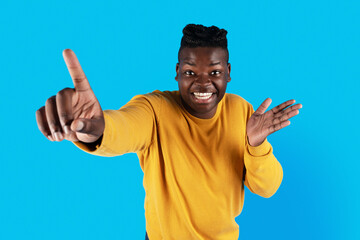 Fototapeta premium Gotcha. Cheerful Young Black Male Poiting At Camera With Finger