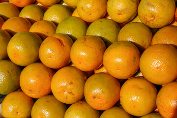 Stack of oranges exposed in open air market stalll