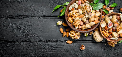 Assortment of different types of nuts in bowls.