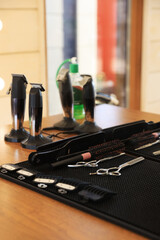 Stylish hairdresser's workplace with professional tools and cosmetic products in barbershop