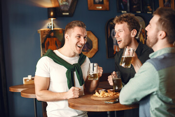 Men celebrate St. Patrick's Day at bar with a mug of beer
