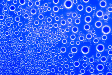 Bubbles blue background.Indigo pattern with white circles. Macro round bubbles texture in blue tones.beautiful Indigo background with circles.macro Bubbles set. 