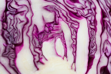 Obraz premium Half of fresh red cabbage as background, closeup