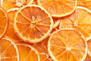 Delicious dry orange slices as background, top view