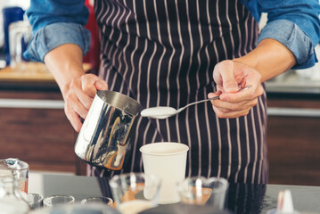 Close up hands coffee barista man make hot cup espresso shot from coffee machine. Cappuccino with milk in italian coffee shop cafe. Close up hands of barista use machine make black drinking hot cup
