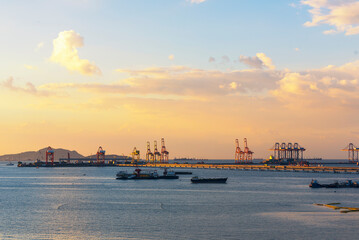 Fototapeta premium Engineering shipping crane depot at logistic export terminal control. Warehouse freight background container yard loading quayside harbor port. Logistics seascape shipping portal concept