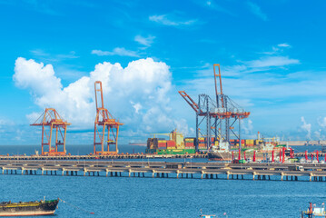 Fototapeta premium Engineering shipping crane depot at logistic export terminal control. Warehouse freight background container yard loading quayside harbor port. Logistics seascape shipping portal concept