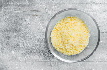 Grated cheese in a glass bowl.