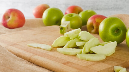 Apple slices close-up on a wooden cutting board