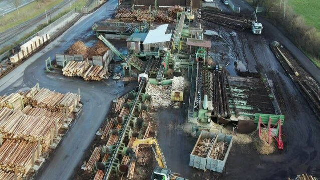 Timber Industry in Action: An Aerial View of Log Loading and Sorting at a Sawmill in Germany